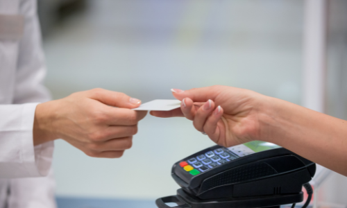 Customer handing cashier a gift card